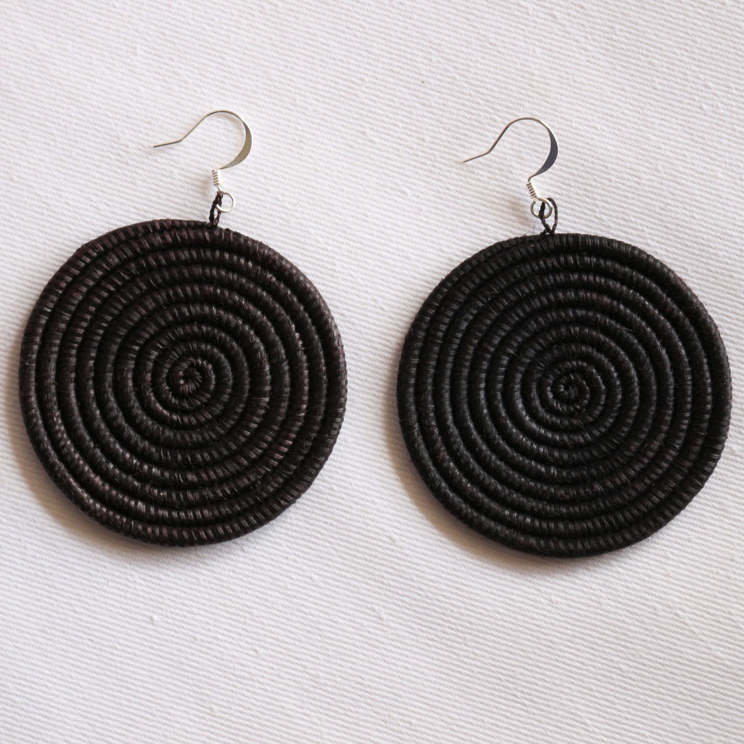 Large woven disc earrings in black by DC-Azizi Life Inc, featuring textured, circular designs perfect for stylish accessories.