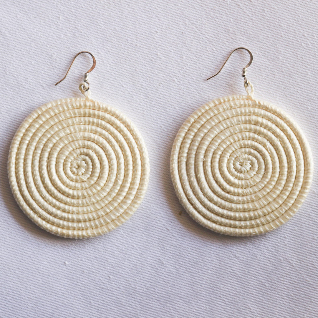 Large woven disc earrings by DC-Azizi Life Inc featuring natural fiber design and handcrafted details.