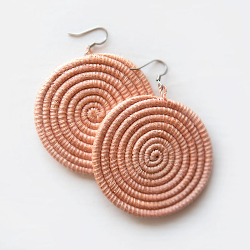 Large woven disc earrings in blush color, featuring intricate weaving on a white background, by DC-Azizi Life Inc.