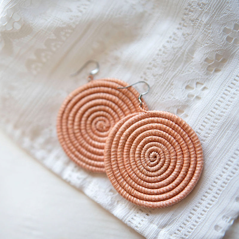 Large woven disc earrings in blush color by DC-Azizi Life Inc, featuring a stylish and textured design.