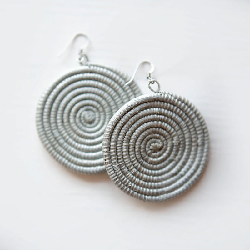 Large woven disc earrings by DC-Azizi Life Inc in icy blue, displayed on a white background.