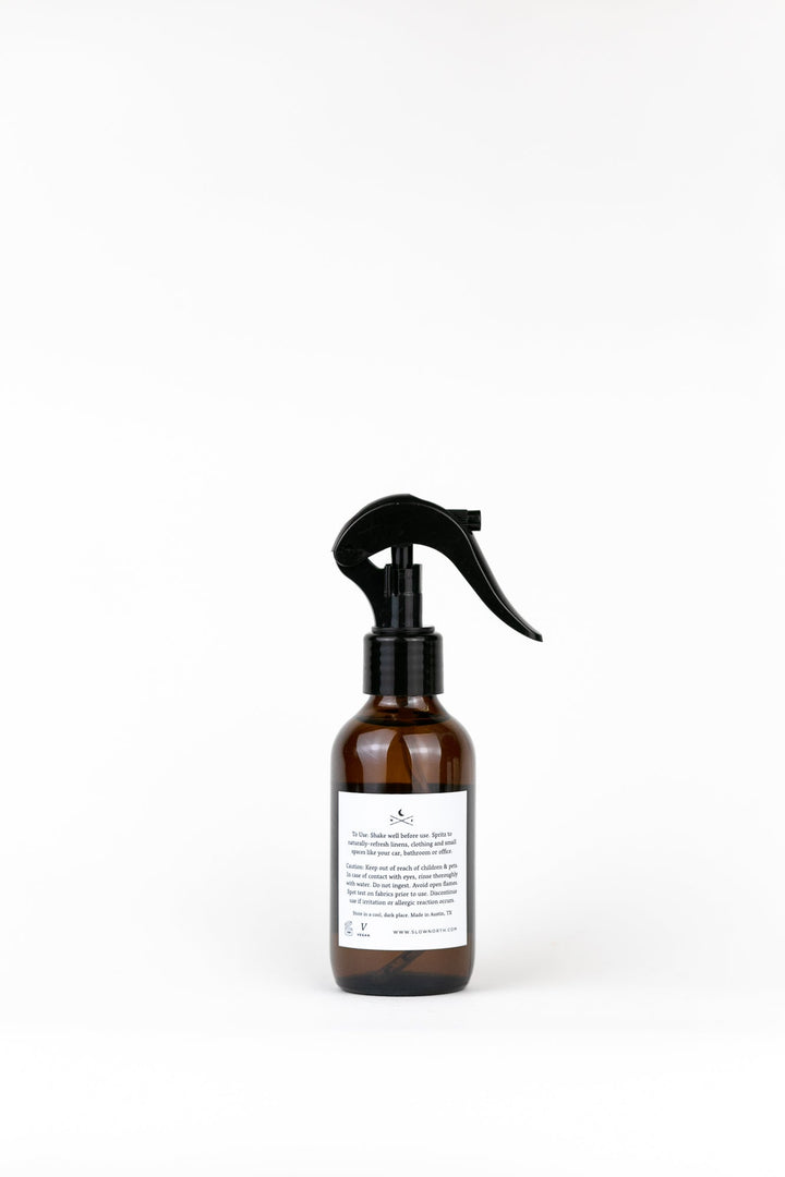 Orange clove linen spray with labeled packaging and spray nozzle.