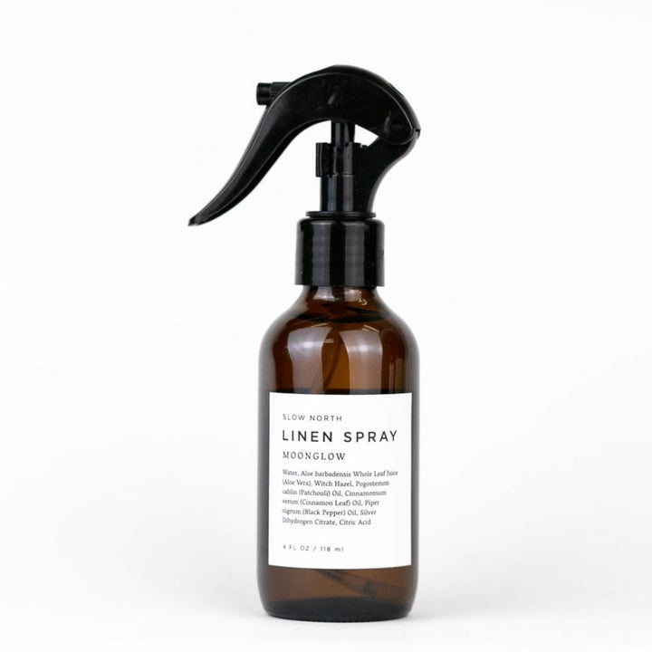 Moonglow linen spray with patchouli and cinnamon in a glass spray bottle.