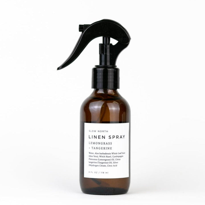 Lemongrass tangerine linen spray in a glass bottle with spray nozzle.