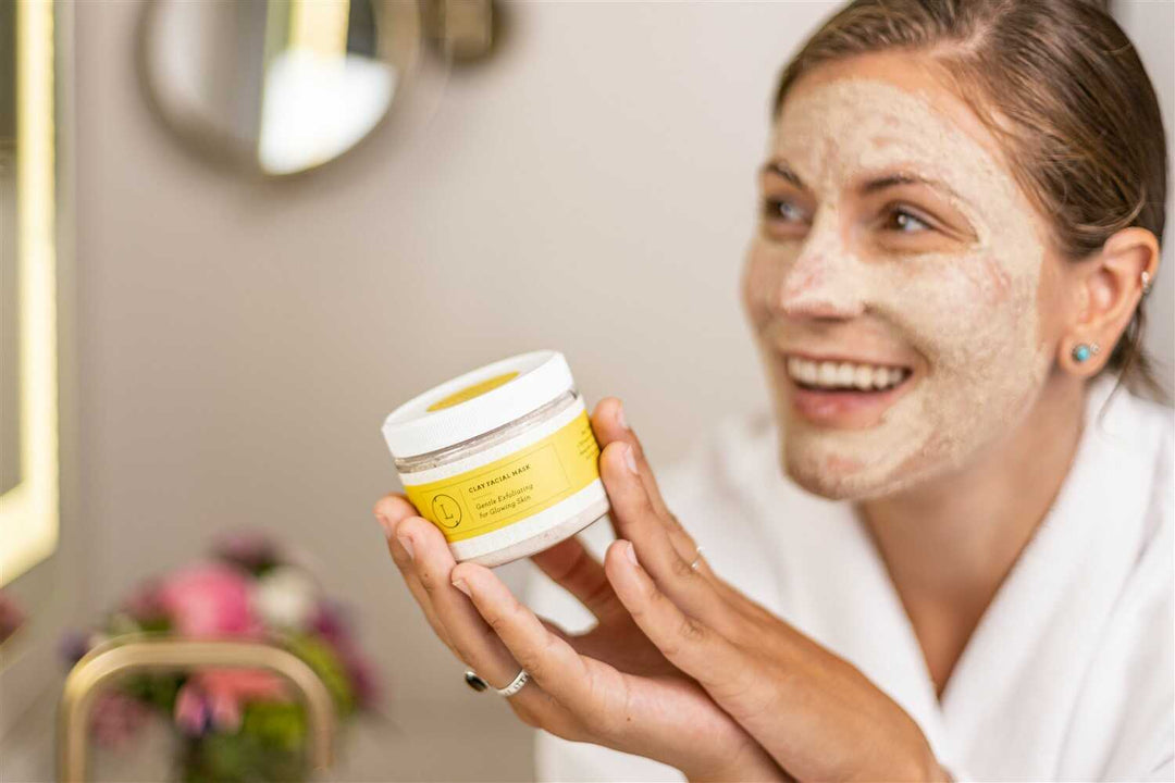 Clay facial mask in a bowl with a smooth texture and applicator brush.