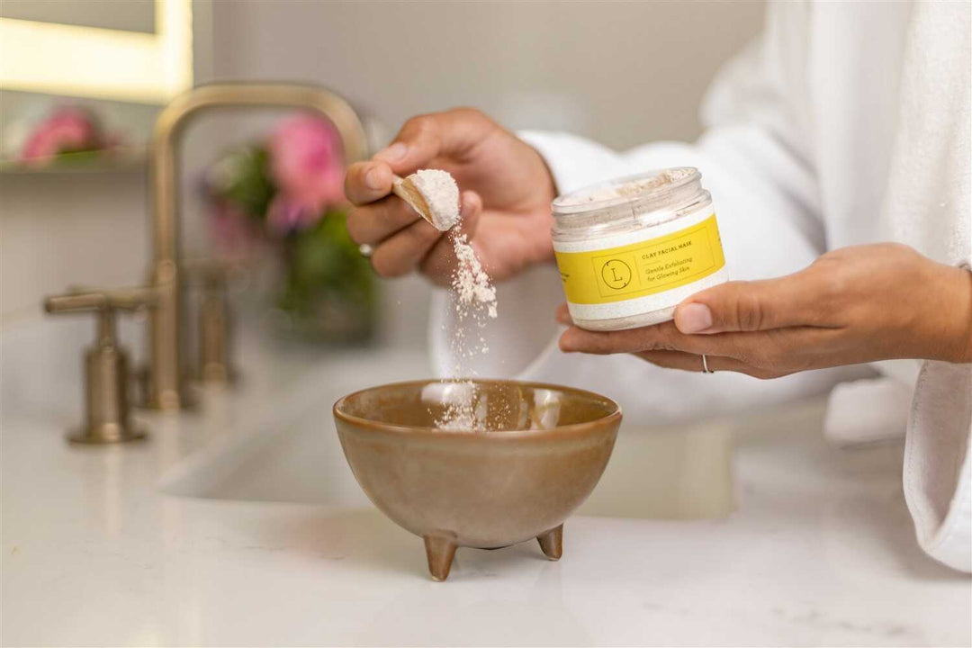 Clay facial mask in a bowl with an application brush.