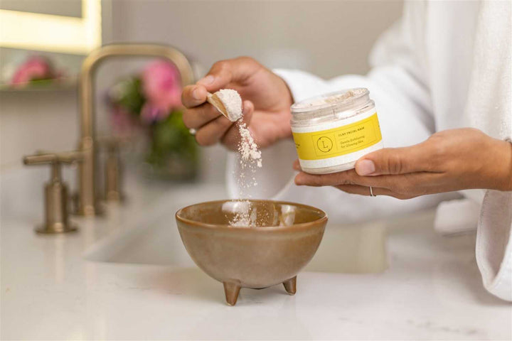 Clay facial mask in a bowl with an application brush.
