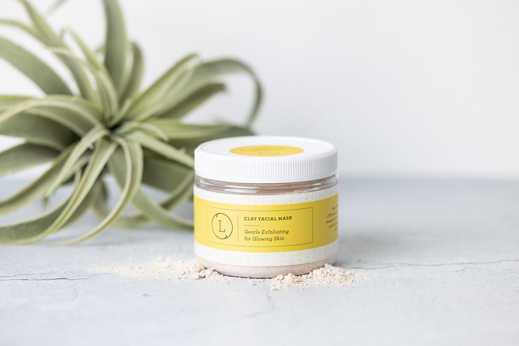 Clay facial mask spread on a palette, showing its natural texture.
