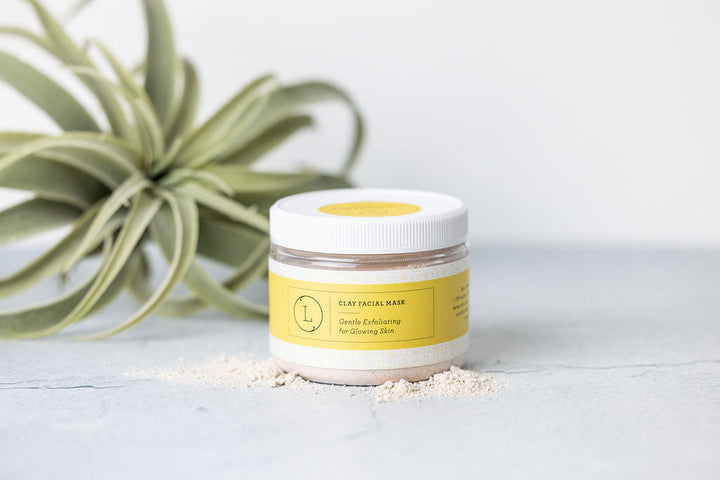Clay facial mask spread on a palette, showing its natural texture.
