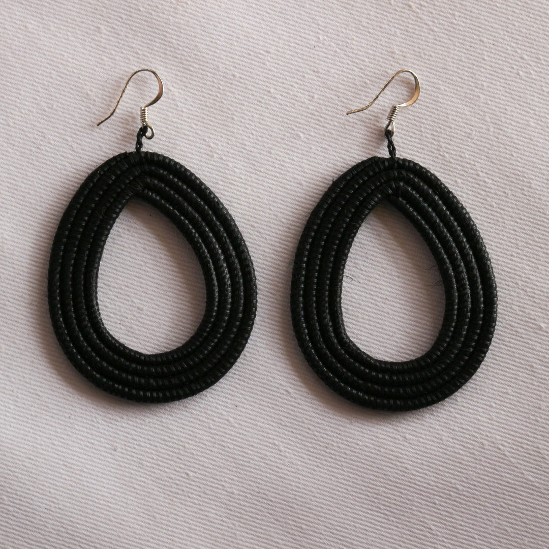 Black woven loop earrings made from natural sisal with a looped design.