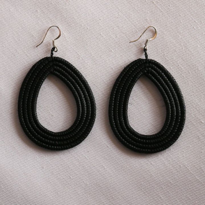 Black woven loop earrings made from natural sisal with a looped design.