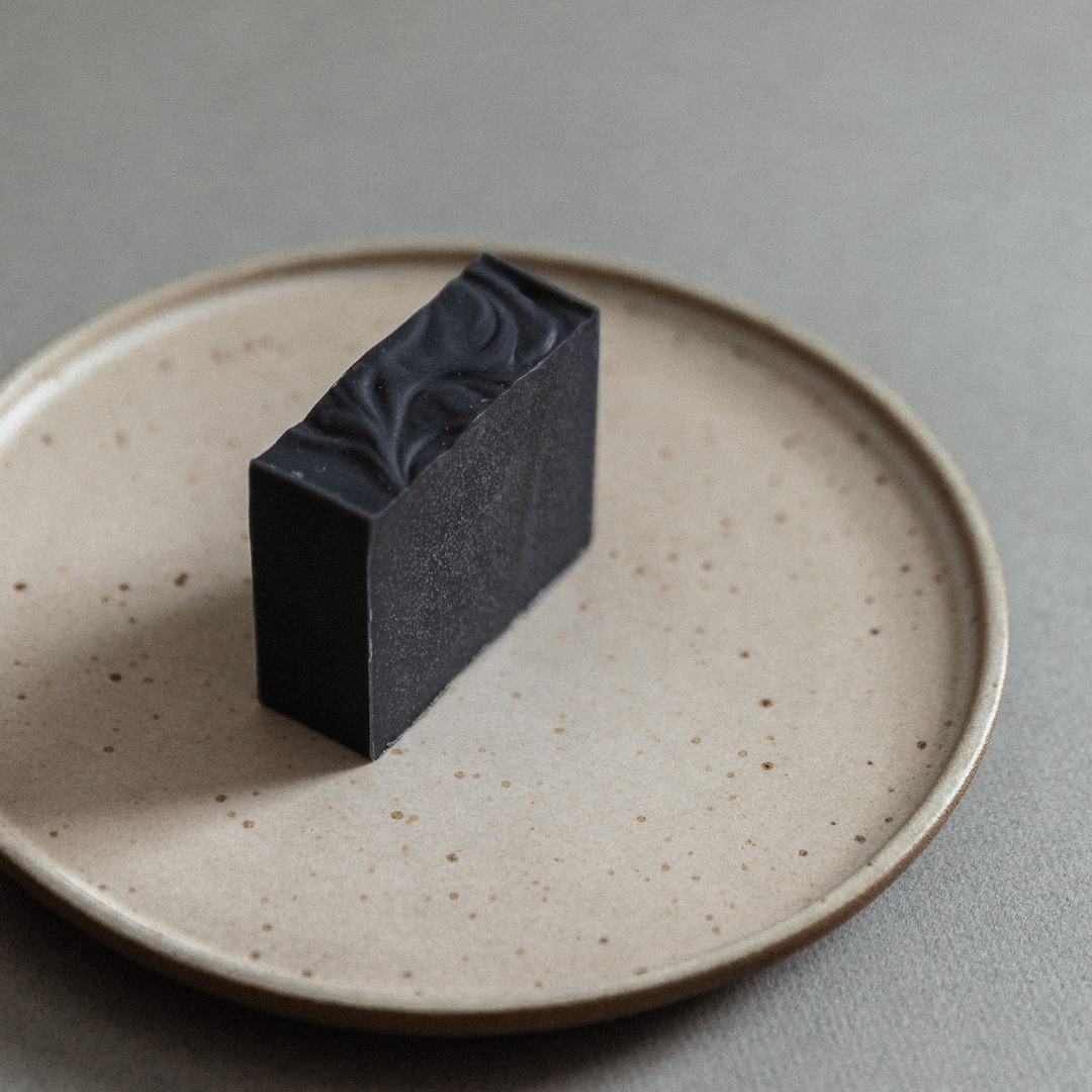Dark soap bar with rustic, textured finish.