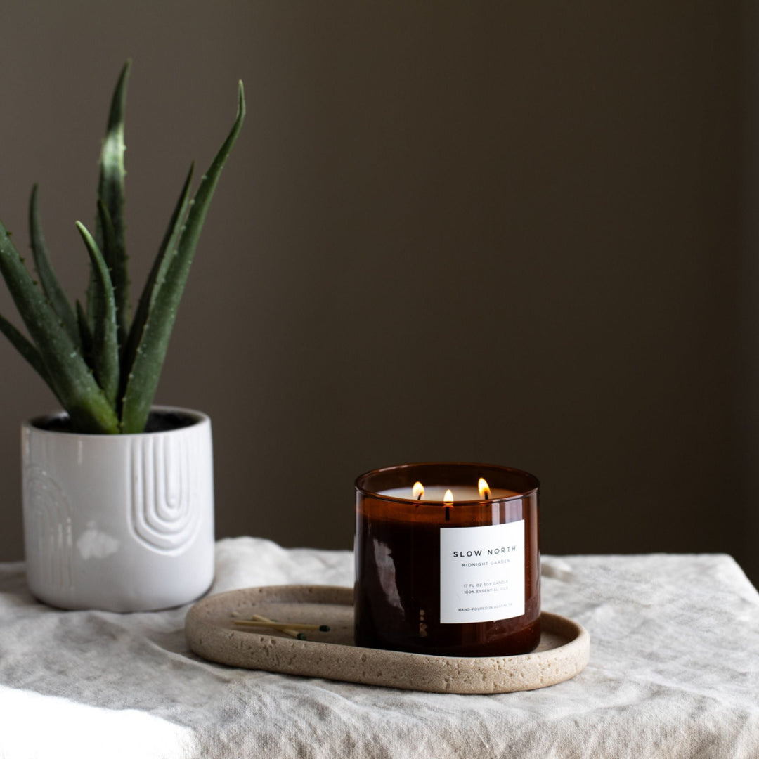 Midnight Garden three-wick candle with floral design and three wicks.