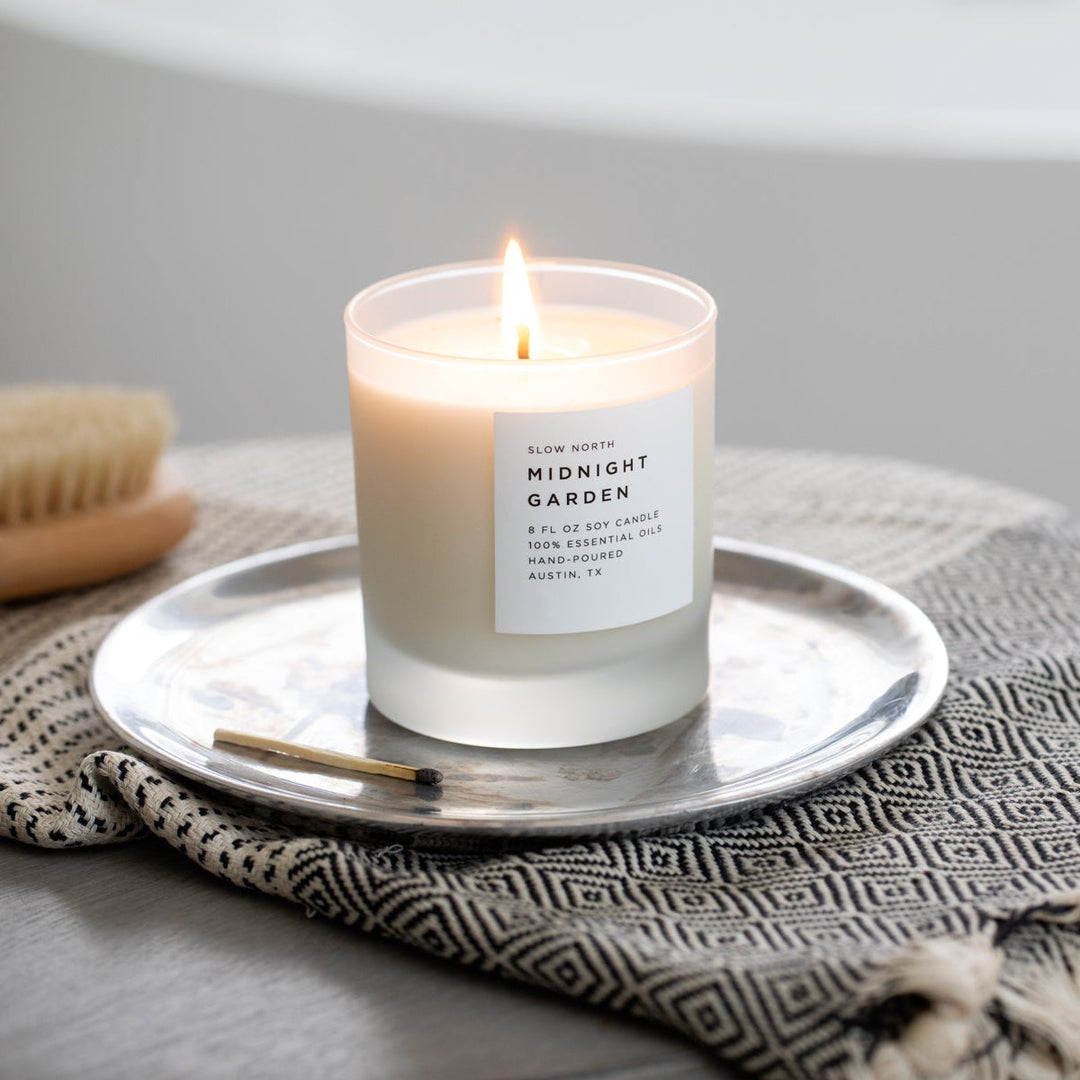 Midnight Garden signature candle with floral design in an elegant glass jar.