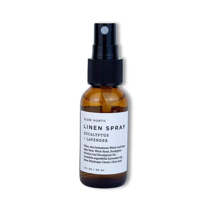 Travel-size eucalyptus lavender linen spray in a small glass spray bottle.