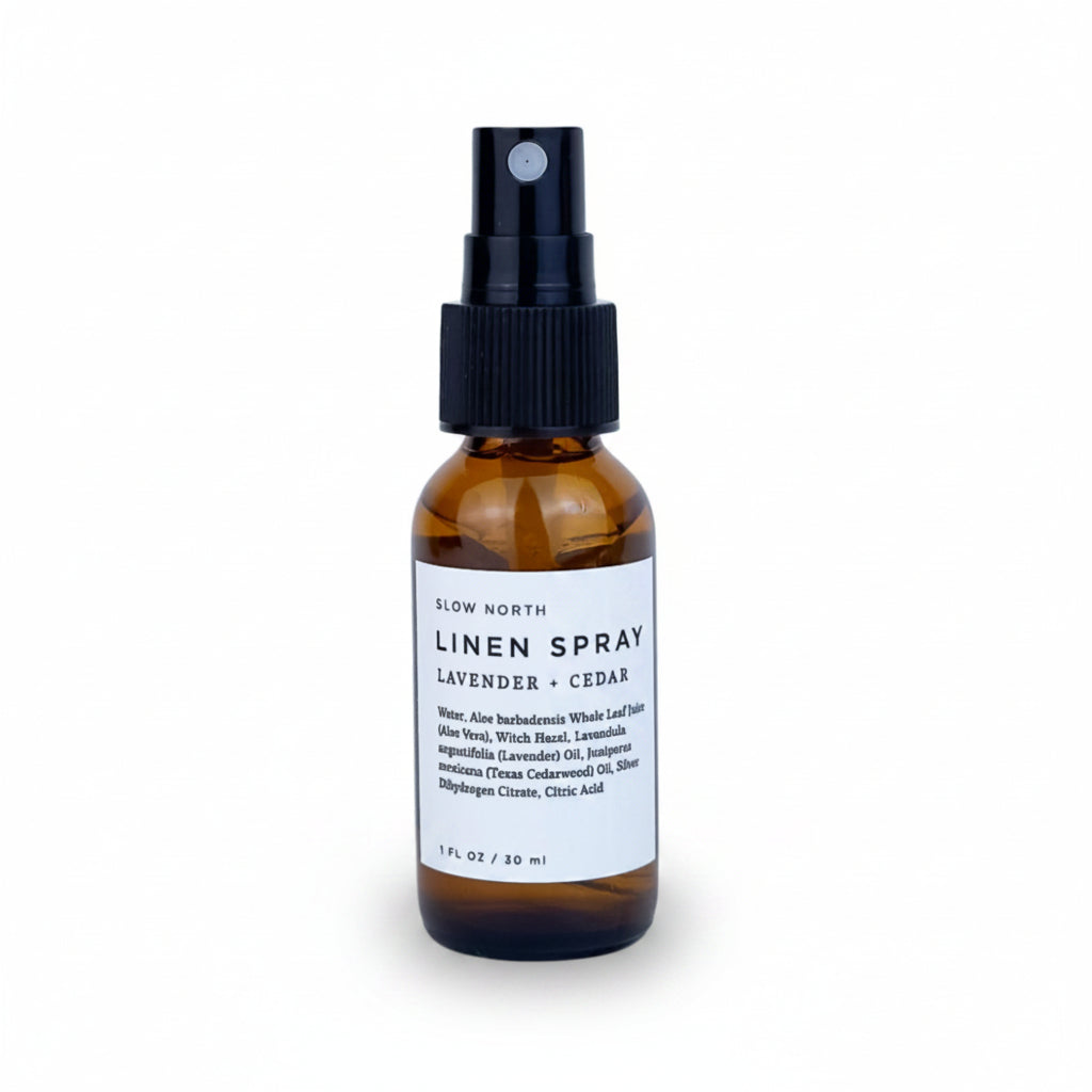 Travel-size lavender cedar linen spray in a compact glass bottle with spray nozzle.