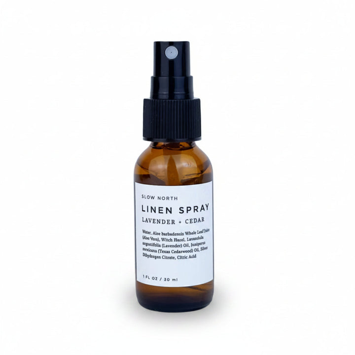 Travel-size lavender cedar linen spray in a compact glass bottle with spray nozzle.