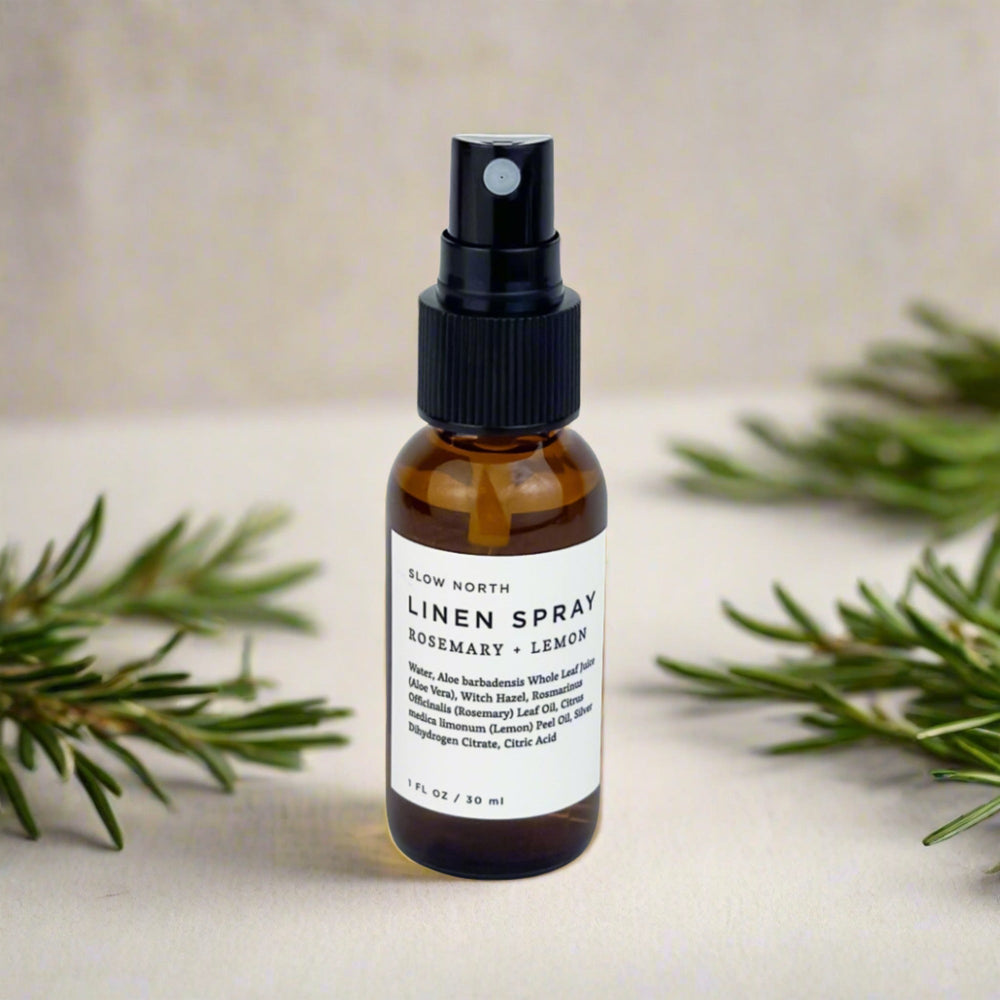 Mini linen spray with rosemary and lemon essential oils and botanical accents.