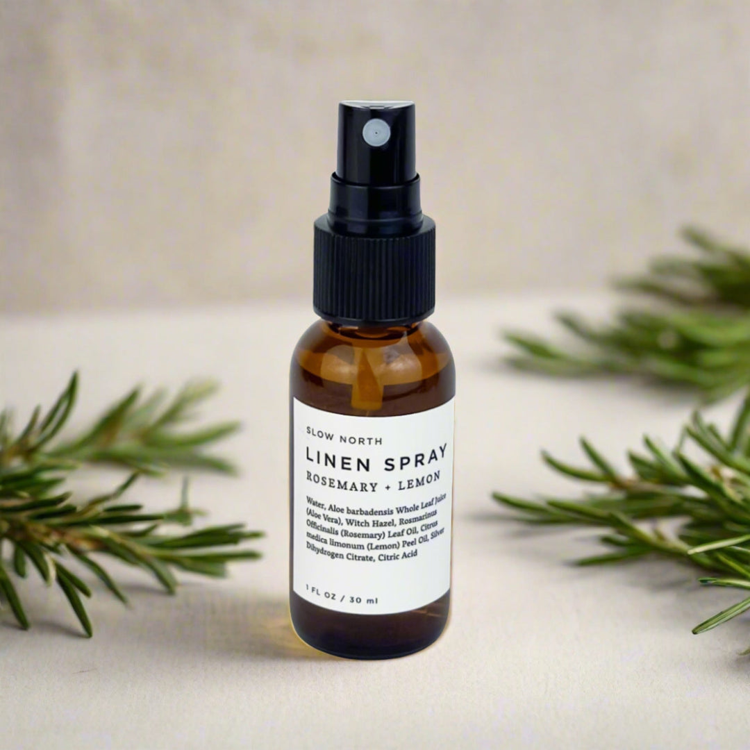 Mini linen spray with rosemary and lemon essential oils and botanical accents.