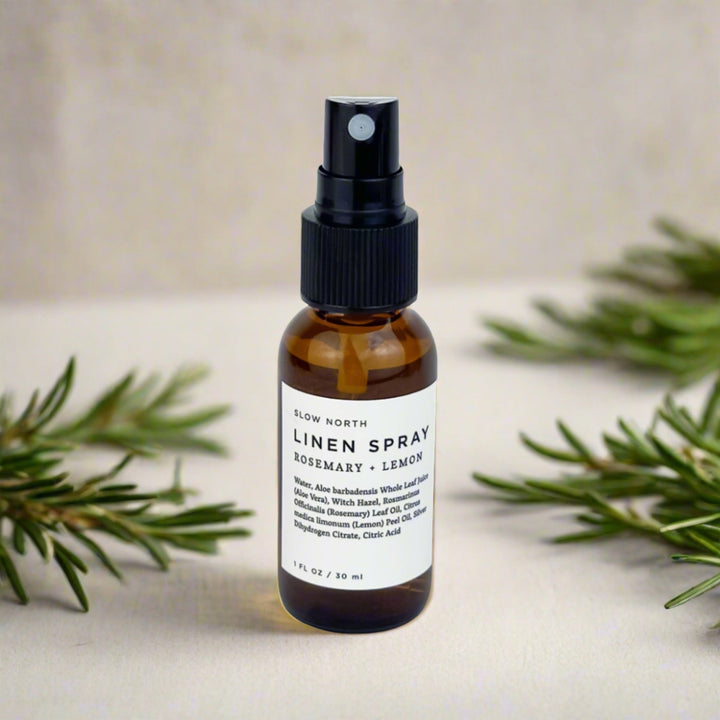 Mini linen spray with rosemary and lemon essential oils and botanical accents.