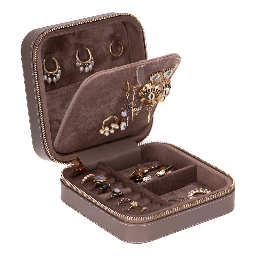 Handcrafted leather jewelry box with compartments for necklaces, rings, and earrings.