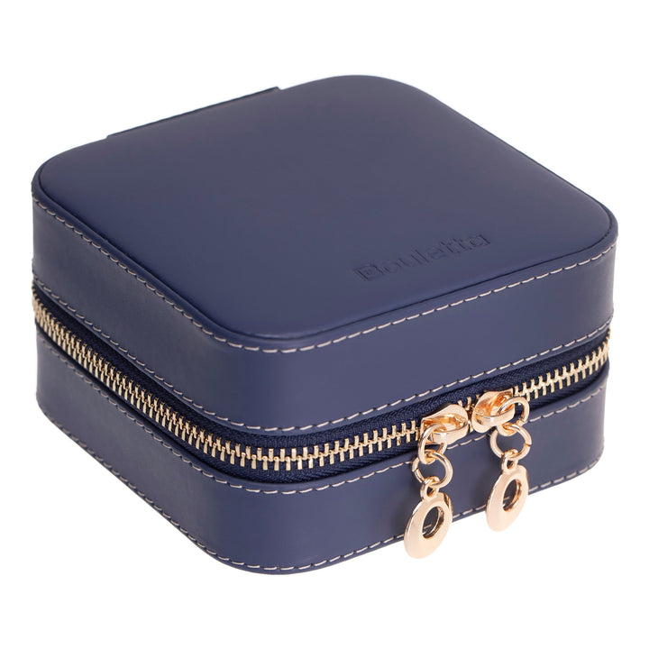Handcrafted leather jewelry box with velvet-lined compartments for rings and earrings.