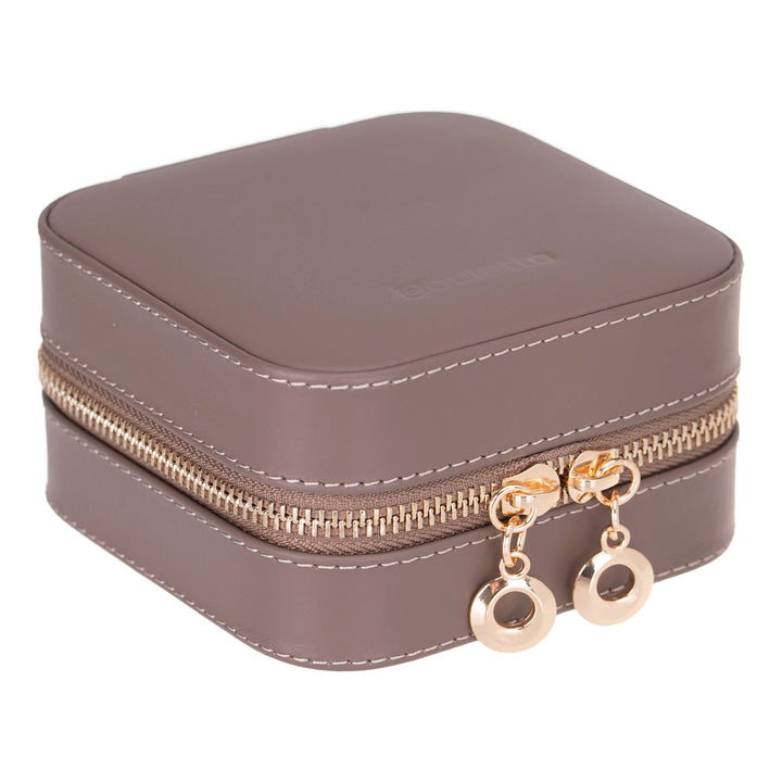Handcrafted leather jewelry box with compartments for necklaces, rings, and earrings.