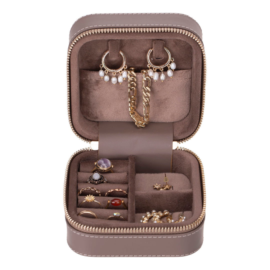 Handcrafted leather jewelry box with multiple compartments and a sleek design.