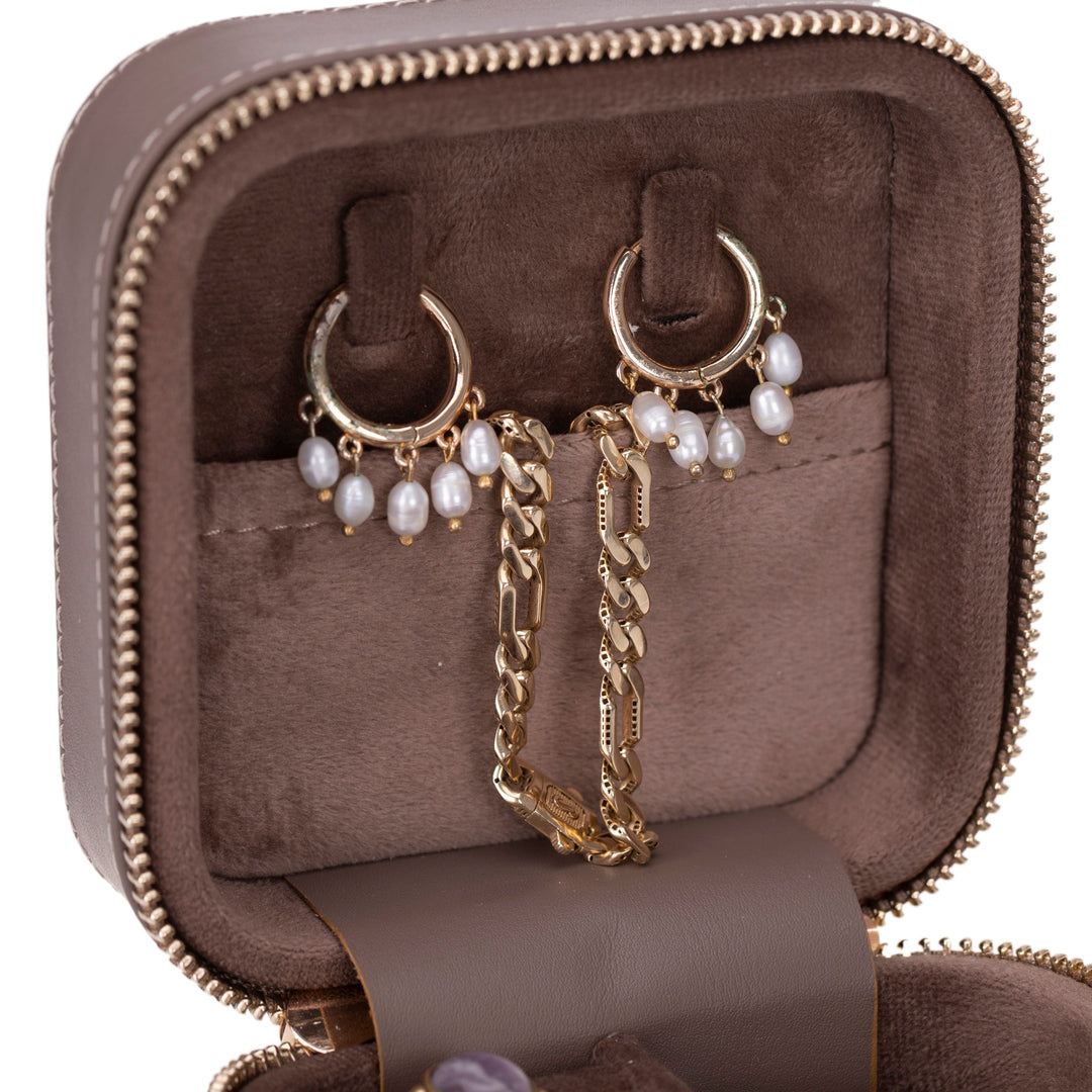 Handcrafted brown leather jewelry box with multiple compartments and detailed stitching.