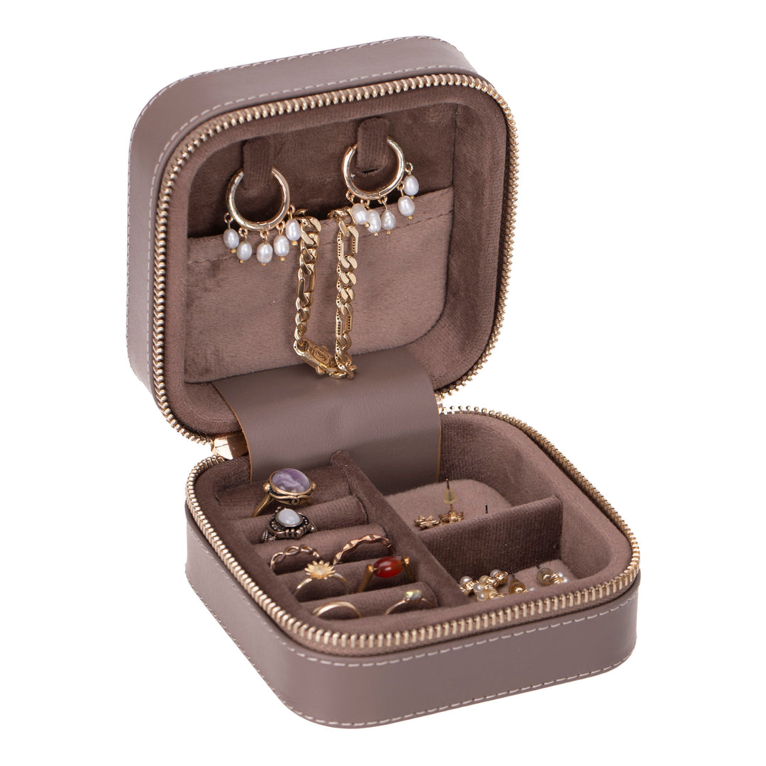 Handcrafted leather jewelry box with compartments for rings, necklaces, and earrings.