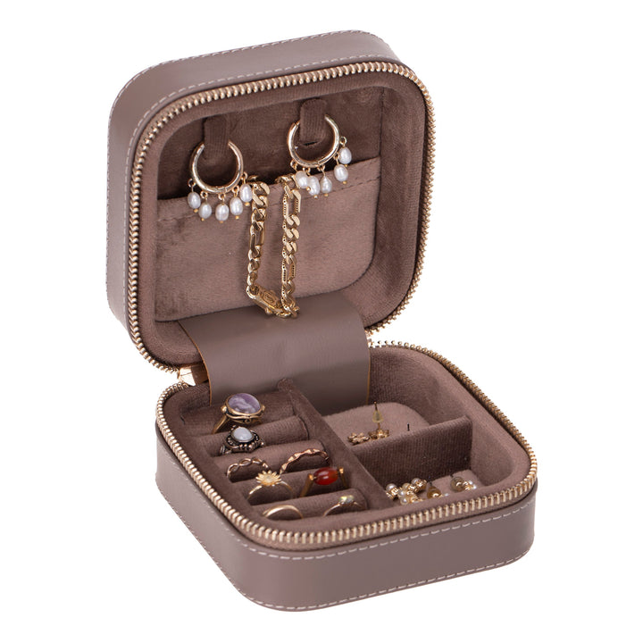 Handcrafted leather jewelry box with compartments for rings, necklaces, and earrings.