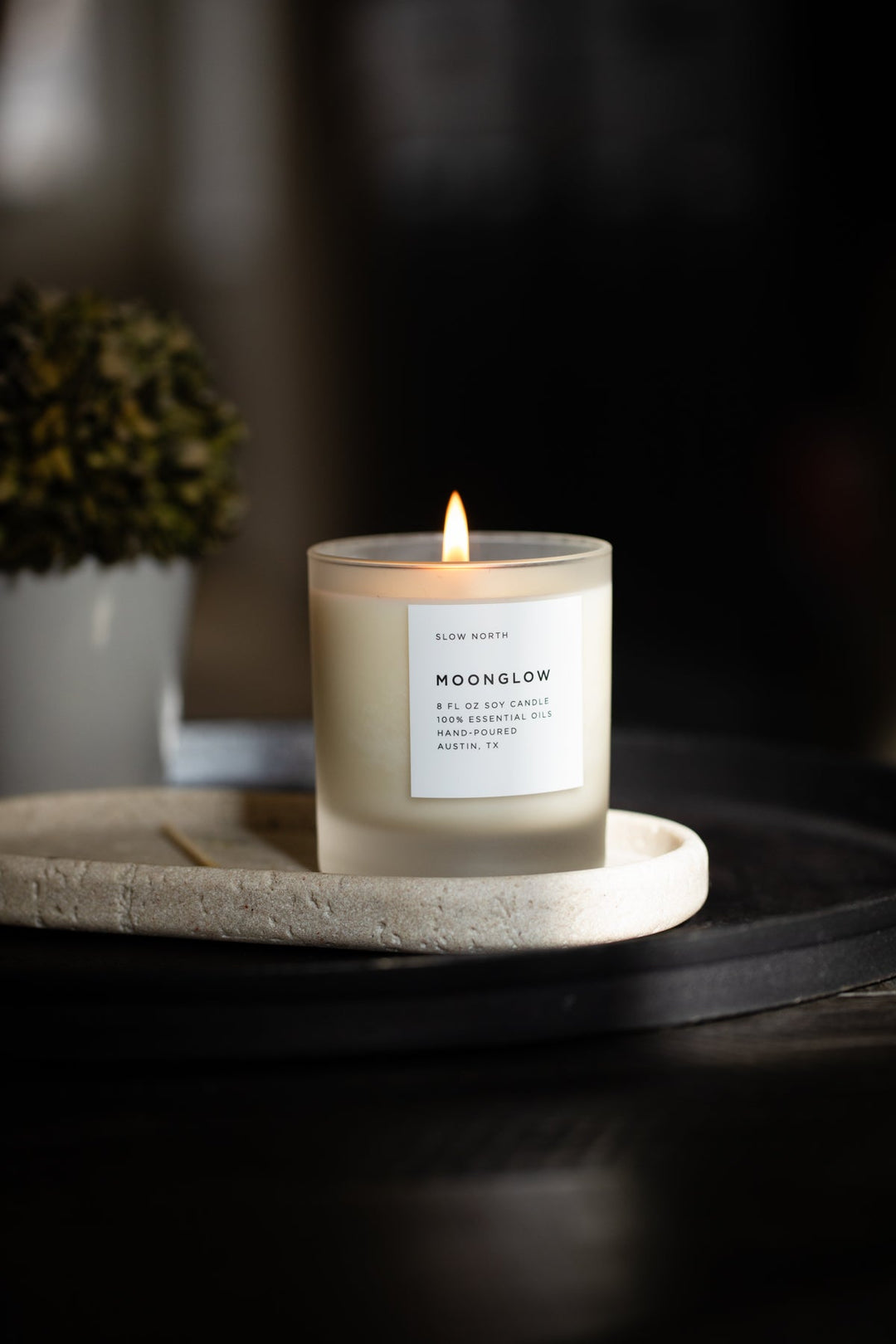 Moonglow candle in a glass jar with warm patchouli and cinnamon scent.
