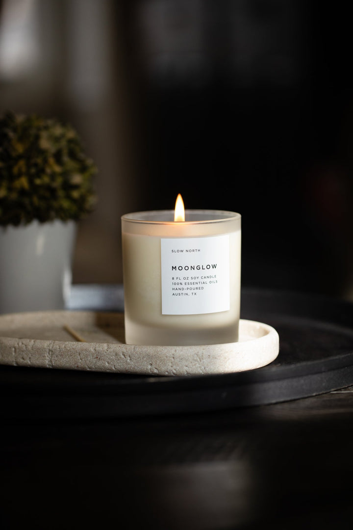 Moonglow candle in a glass jar with warm patchouli and cinnamon scent.