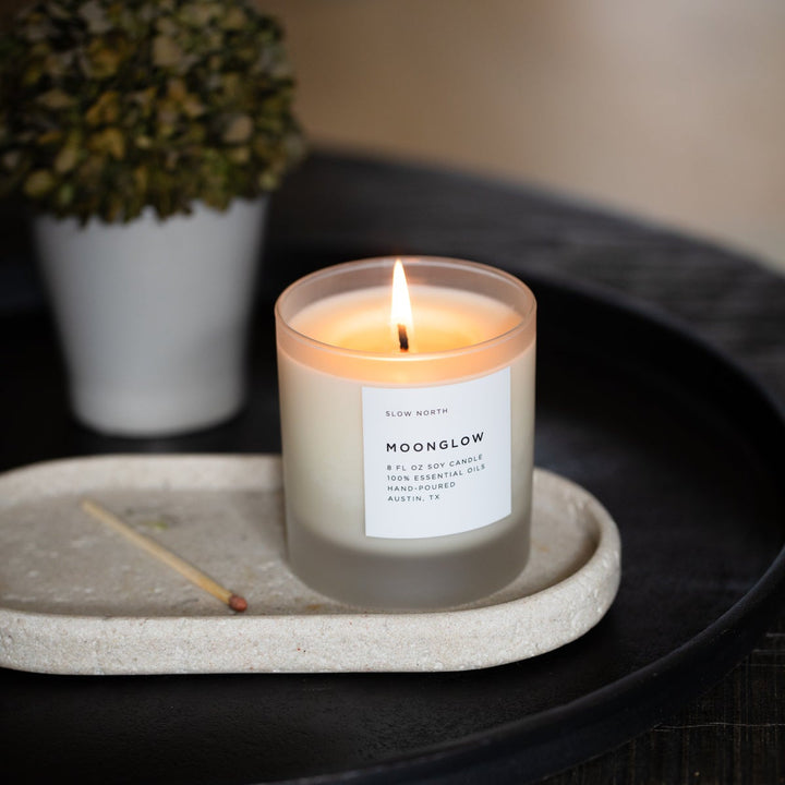 Moonglow signature candle with patchouli and cinnamon in a glass jar.