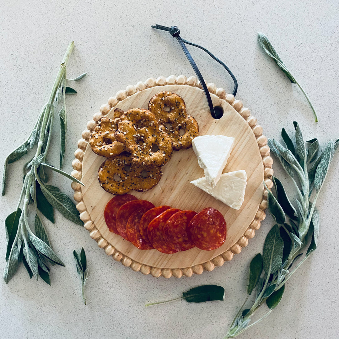 Hand-carved round mini serving board with a smooth finish for appetizers.