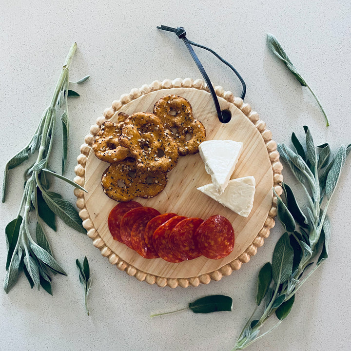Hand-carved round mini serving board with a smooth finish for appetizers.
