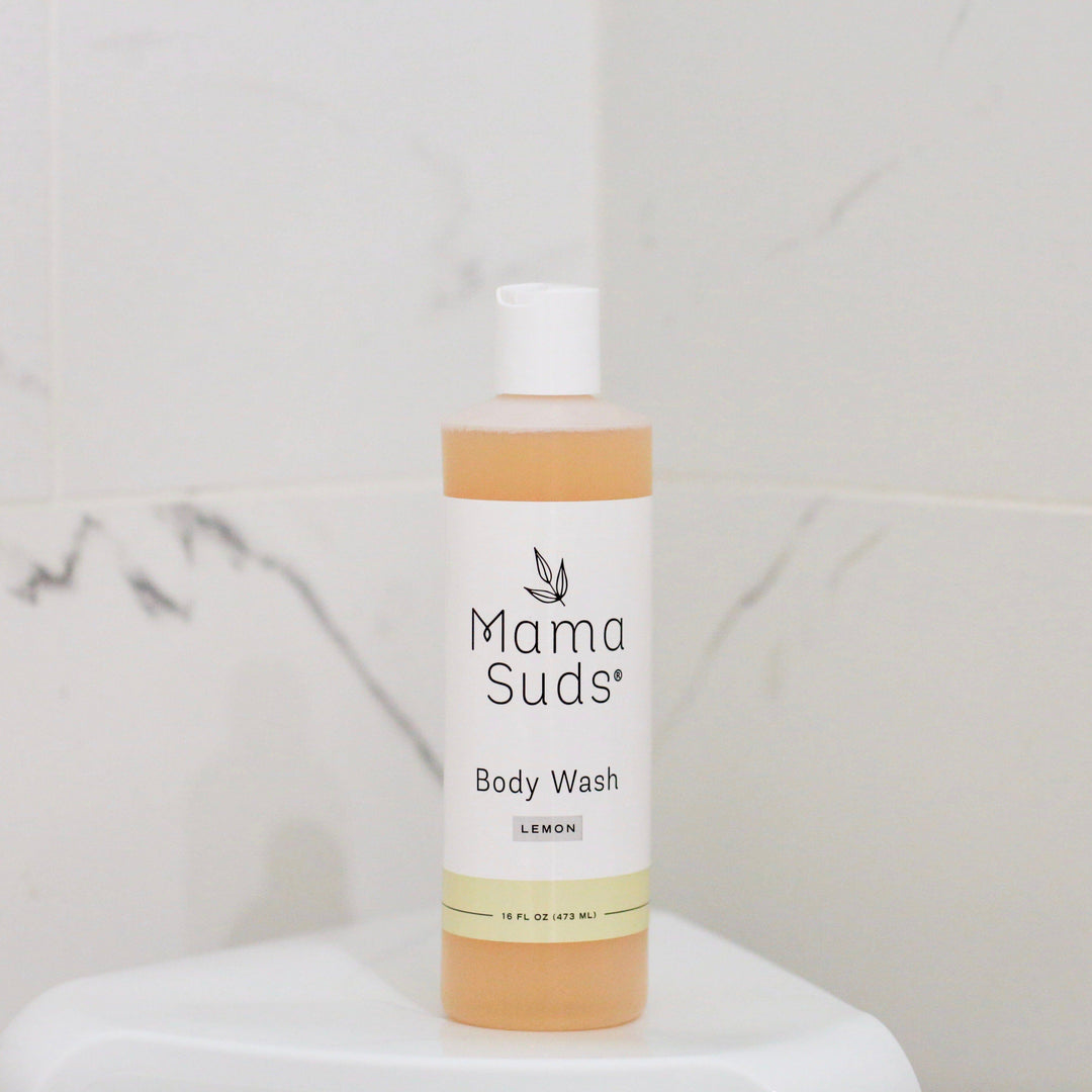 Lemon plant-based castile body wash in a clear bottle with a yellow label.