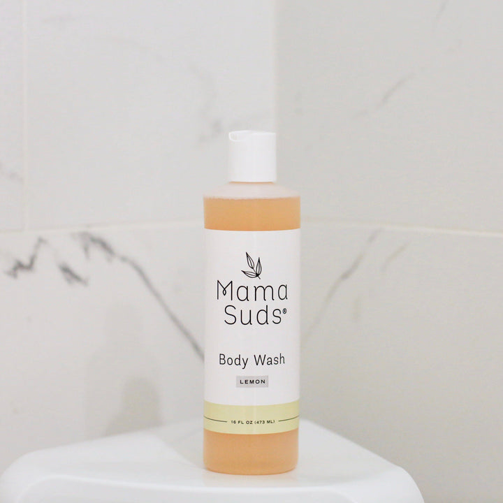 Lemon plant-based castile body wash in a clear bottle with a yellow label.
