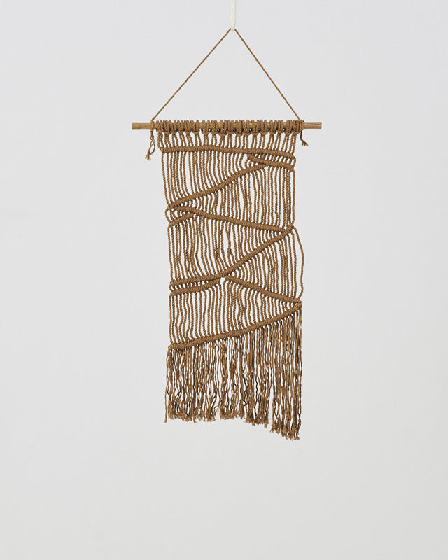 Khaki macrame wall hanging with intricate knot detail.