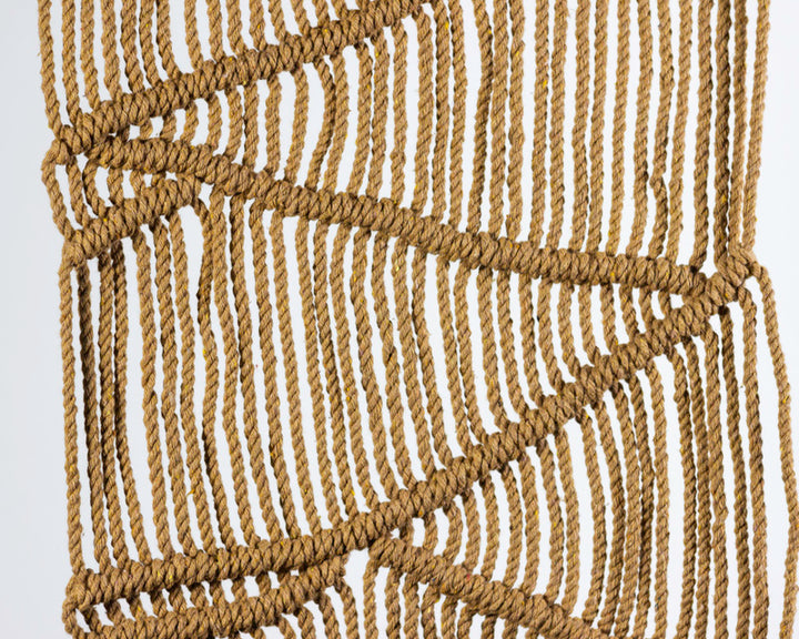 Khaki macrame wall hanging with a boho-inspired knotted design.