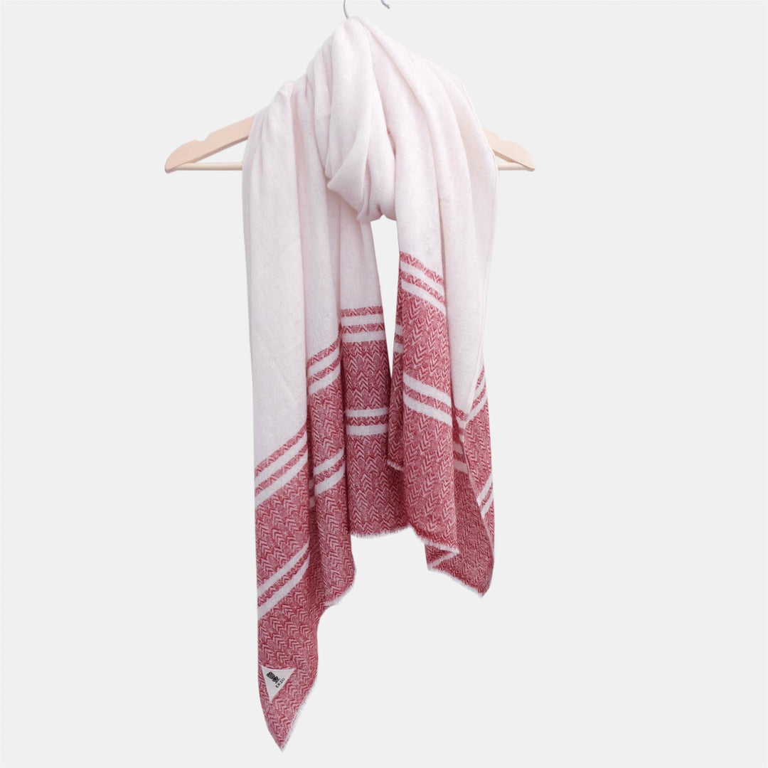 Handwoven cashmere scarf in the Merry design, with a soft texture and intricate weave.