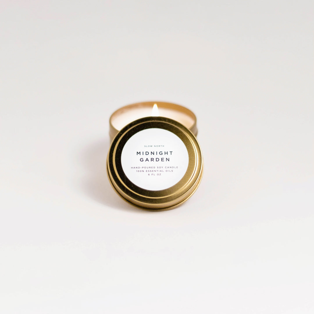 Midnight Garden travel tin candle with dark floral label design.