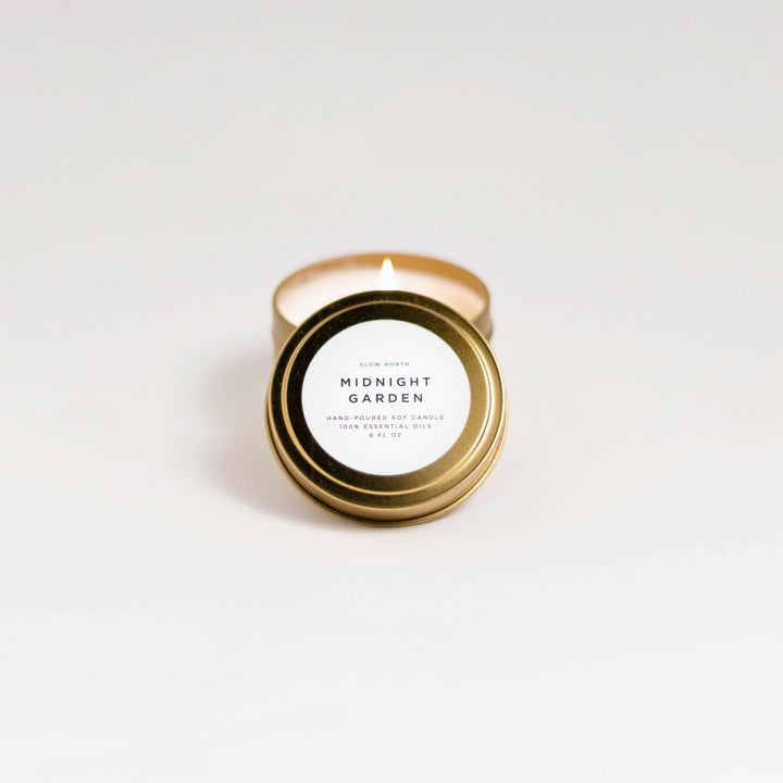 Midnight Garden travel tin candle with dark floral label design.