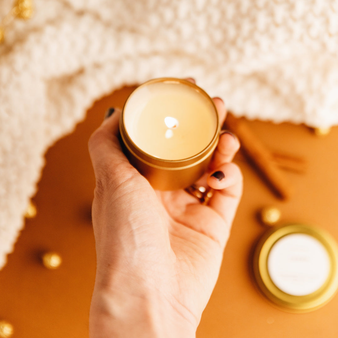 Mini essential oil soy candle in a 2 oz brushed gold travel tin.