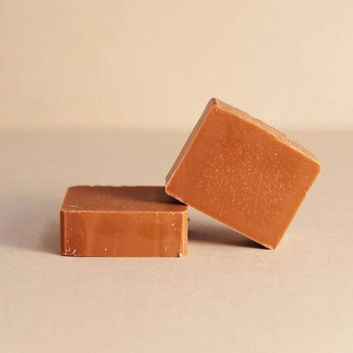 Spice-scented bar soap with kraft paper wrap and minimal styling.