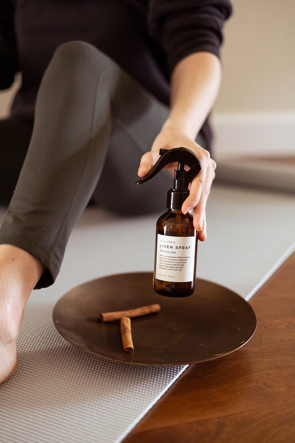 Linen spray bottle with warm spice scent profile and minimalist design.