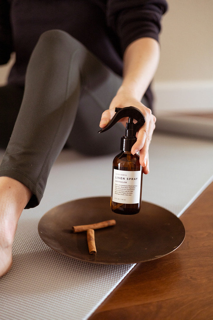 Linen spray bottle with warm spice scent profile and minimalist design.