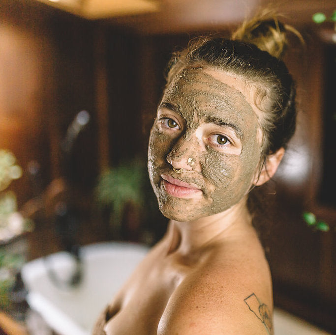 Kapha cleanser and mask with French green clay in a skincare setup.