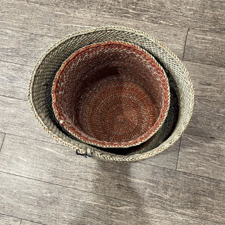 Looking down into a terracotta Auburn basket nested inside a pale natural grass basket