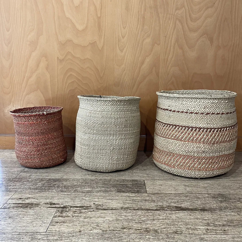 A terracotta Auburn medium, natural large and Auburn Stripe extra large basket lined up as a mixed set